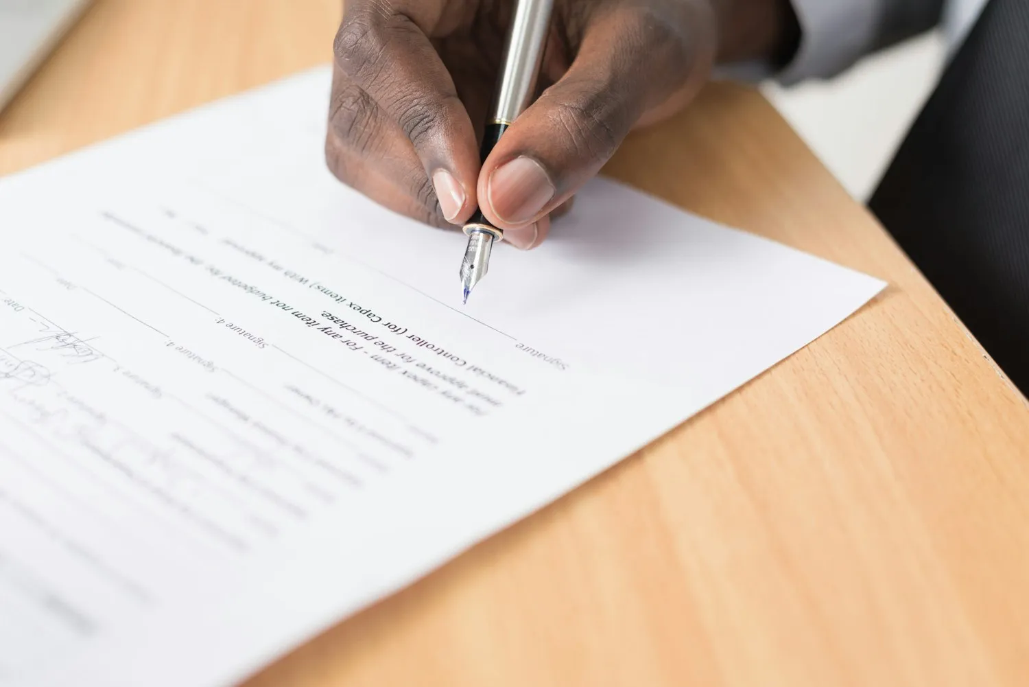Signing planning documents at a desk